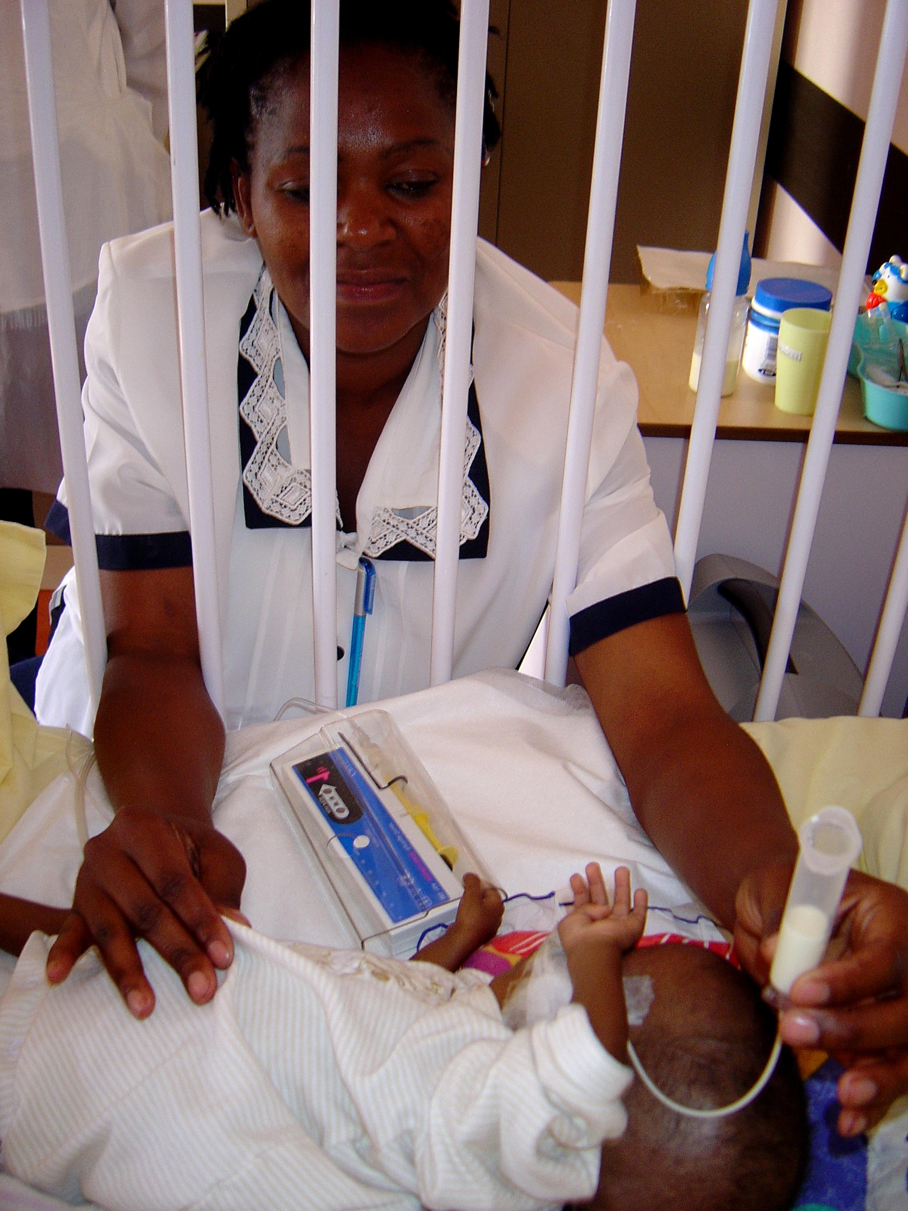 Nurse comforting patient in hospital